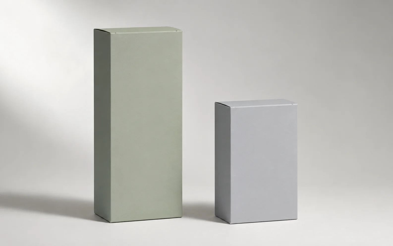 Two unbranded medication boxes of clearly different heights side by side