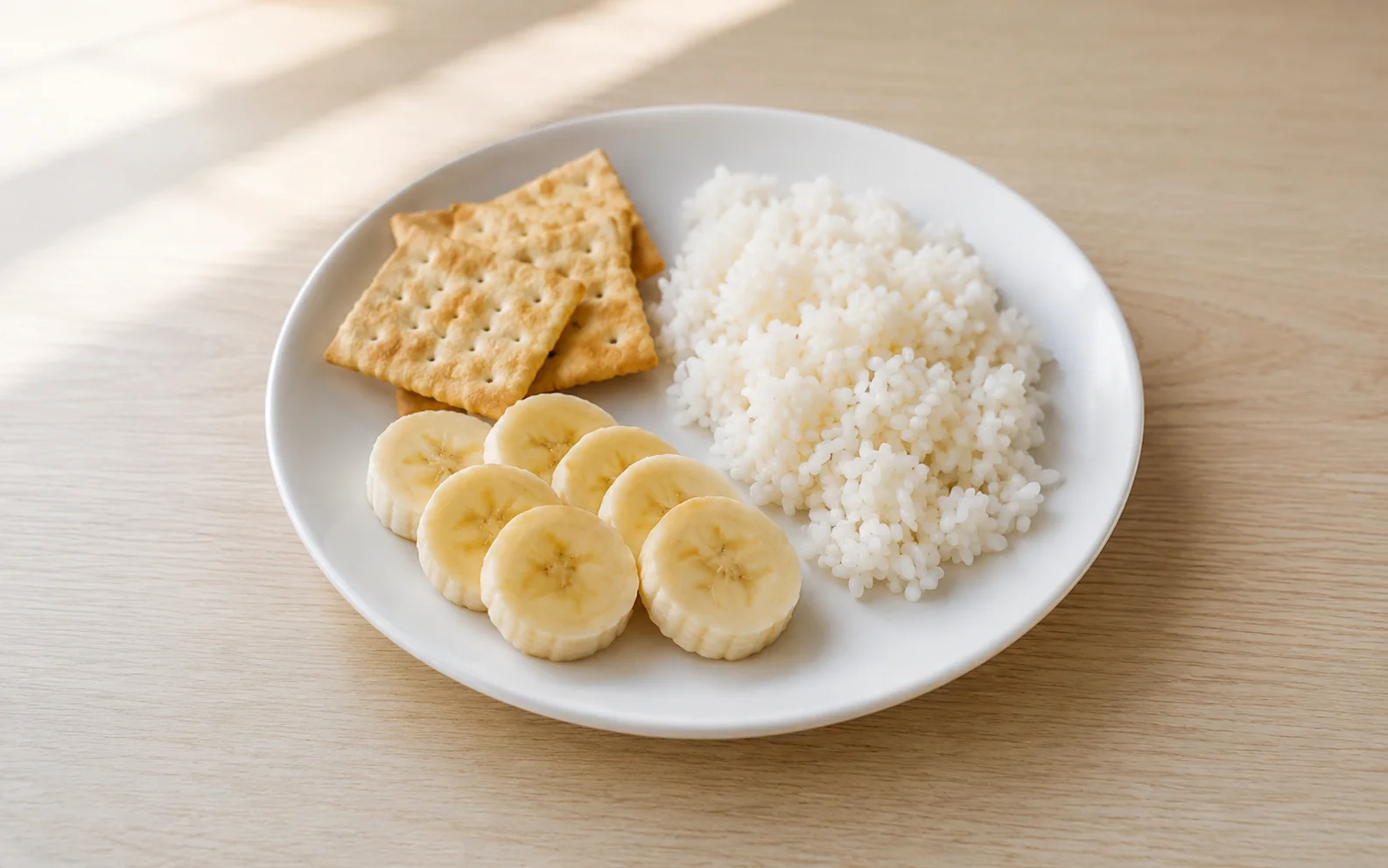 A small plate of plain bland foods on a calm light surface
