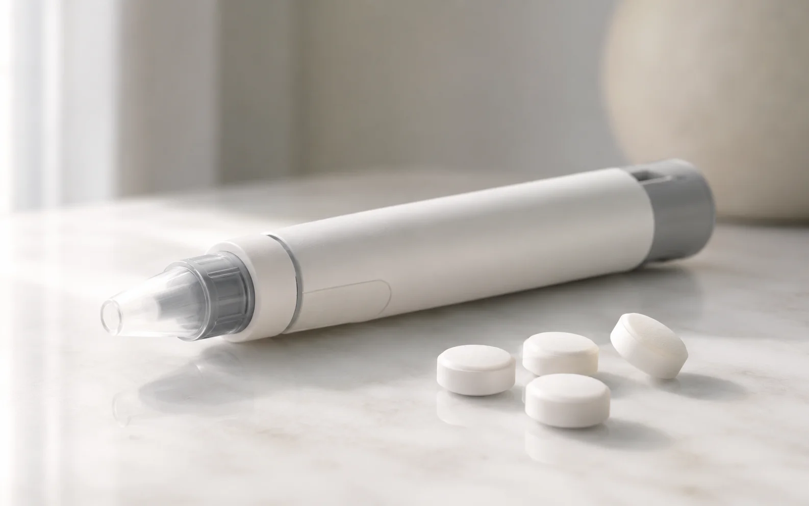 A plain unbranded medical injector pen beside plain unmarked tablets on a clean clinical surface