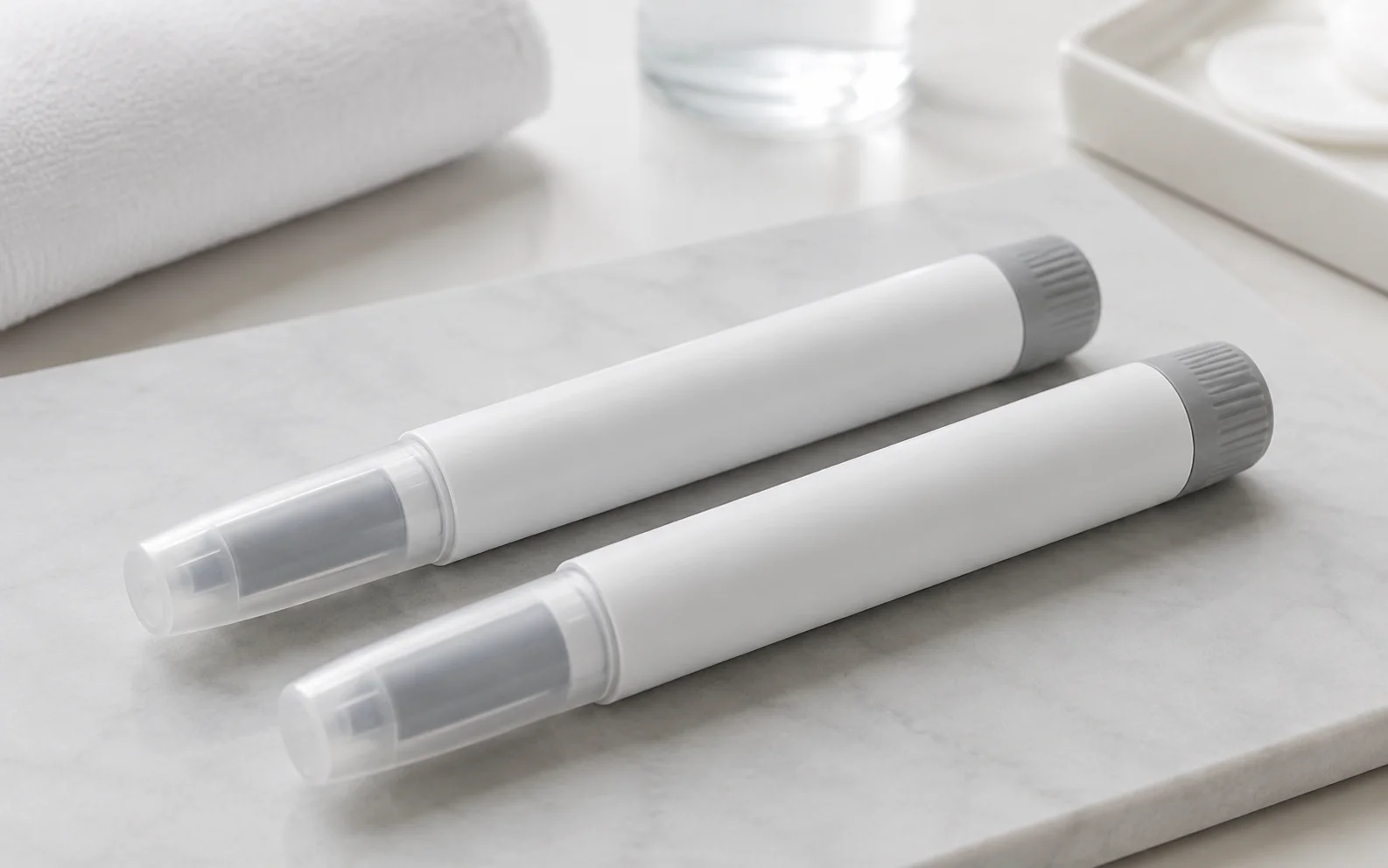 Two plain unbranded medical injector pens arranged on a clean clinical surface